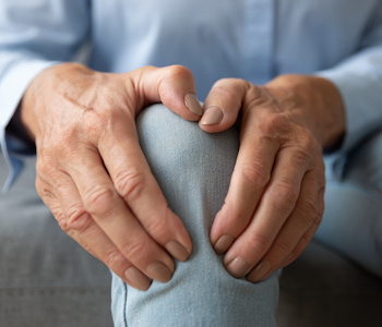 person holding knee in pain